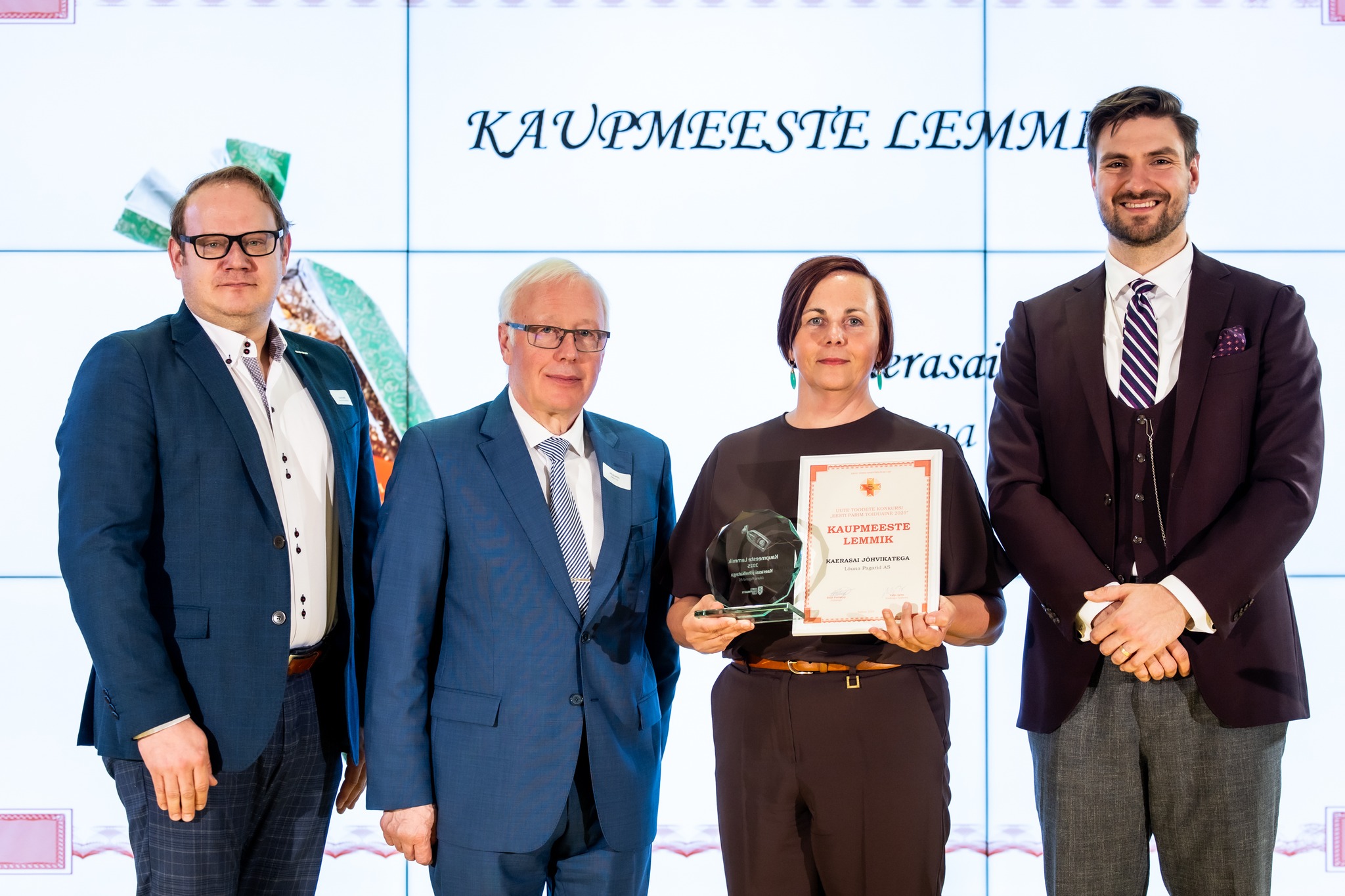 Coop Eesti ostudirektor (vasakpoolseim) andis üle kaupmeeste lemmikule auhinna.